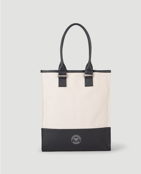 A cream shopper bag with a black leather handle and base. The base is embossed with a white Cross-Racket logo.